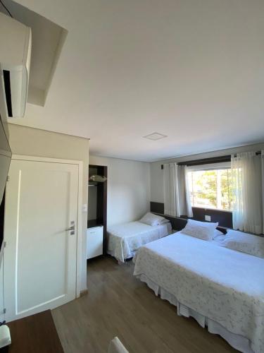 Ένα ή περισσότερα κρεβάτια σε δωμάτιο στο Hotel Recanto dos Ipes