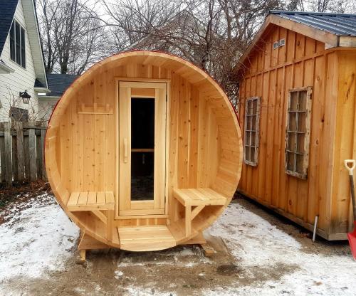 a large wooden sauna with a large wooden door at Driftwood Haus in Southampton