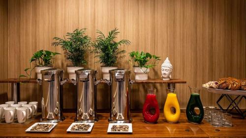 a table with a group of vases and plants at The Royal Sonesta Portland Downtown in Portland