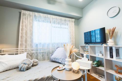 a bedroom with a bed and a window at HARMONIA東京堀切403 in Tokyo