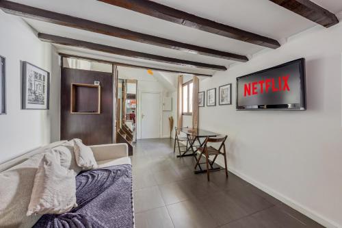 a living room with a couch and a table at L'Hypercentre / 1 min RER A - 5 min Métro - Disney in Vincennes