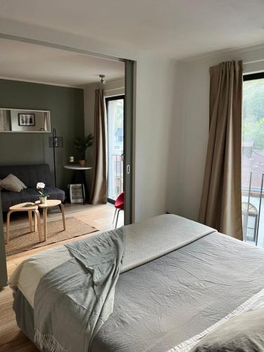 a bedroom with a bed and a living room at Departamento Barrio Lastarria in Santiago