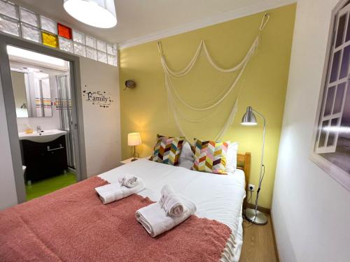 a bedroom with a large bed with towels on it at Olhão Beach Apartment 2 by Homing in Olhão
