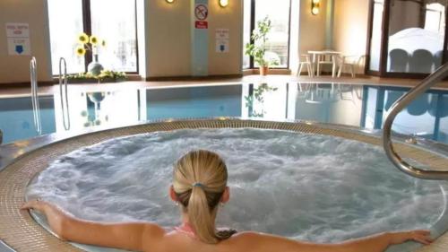 a little girl in a jacuzzi tub in a pool at Scotland's Spa Hotel in Pitlochry
