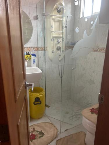 a bathroom with a shower and a toilet and a sink at Villadorado in Bogotá