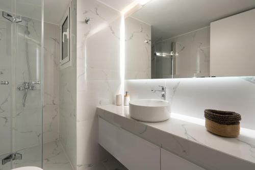 a white bathroom with a sink and a shower at Charming two bedrooms Apartment walk to Acropolis in Athens