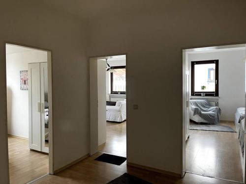 an empty room with two doors and a bedroom at Wunderschöne 3-Zimmer Wohnung für 8 Personen in Bremen