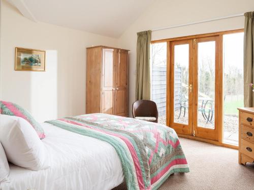a bedroom with a bed and a sliding glass door at 2 bed in Ashford 49685 in Egerton