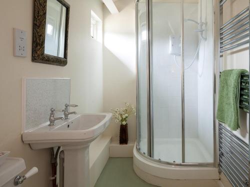 a white bathroom with a sink and a shower at 2 bed in Ashford 49685 in Egerton