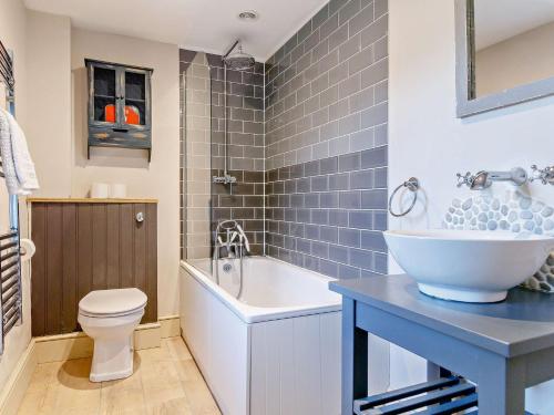 a bathroom with a tub and a toilet and a sink at 1 bed property in Bradford-On-Avon 82251 in Bradford on Avon