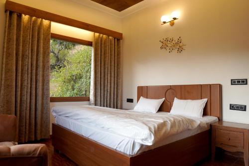 Bhowāli的住宿－Galaxy Stay Casa，一间卧室设有一张大床和一个窗户。