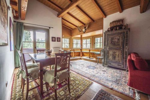 a dining room with a table and a fireplace at Holiday home in Campo Carlo Magno 24162 in Madonna di Campiglio