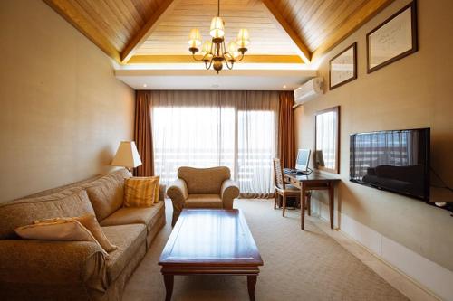 a living room with a couch and a table at Damyang Spa and Tourist Hotel in Damyang