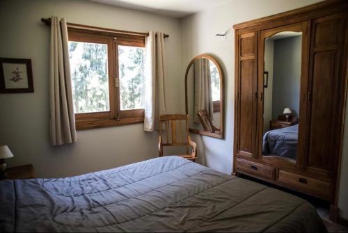 a bedroom with a bed and a large window at Chacra Los Arándanos in Durazno