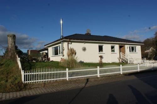 a white house with a white picket fence at Ferienhaus Landhaus Klein in Erbach