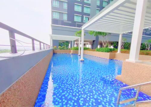 a swimming pool on the side of a building at Cozy Ensuite Modern High-Floor Retreat #GA6 in Shah Alam