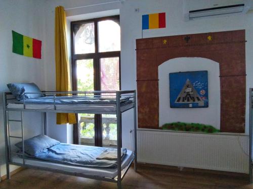 two bunk beds in a room with a fireplace at Bucuresti Bucuresti Hostel in Bucharest