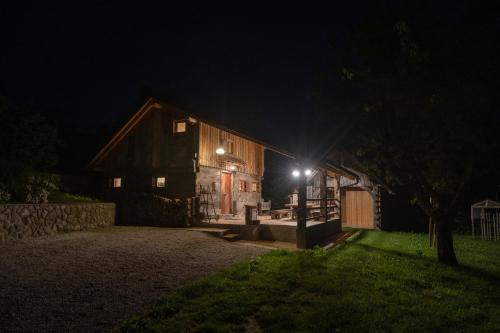 a barn at night with the lights on at MARRYS APARTMENTS in Polica