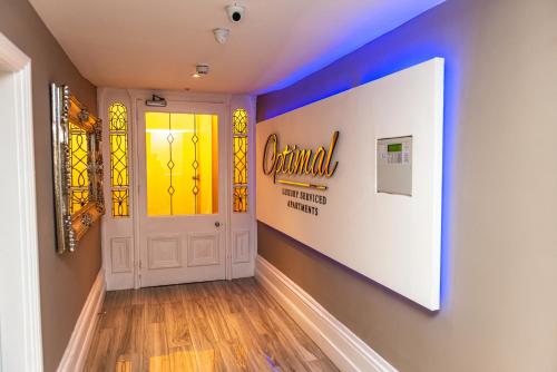 a hallway with a door with a stained glass window at Optimal Apartments in Bradford