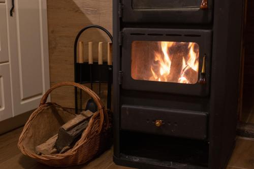 a black stove with a basket next to it at MARRYS APARTMENTS in Polica