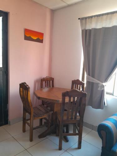 a dining room with a wooden table and chairs at departamento familiar, Tarija te espera!! in Tarija