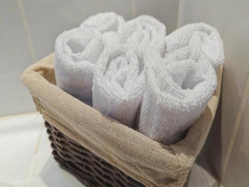 a basket filled with white towels sitting on a counter at Apartment Equipped With Excellent Location in Liberia