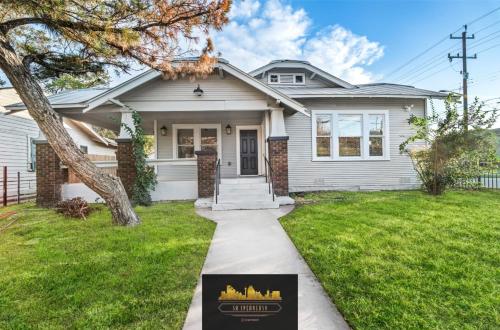 a house with a sign in the front yard at Bold Bright 4BR3.5FULL BATHS Near Riverwalk Dtown in San Antonio