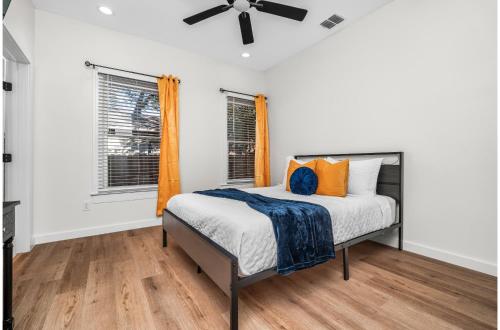 a bedroom with a bed and two windows at Bold Bright 4BR3.5FULL BATHS Near Riverwalk Dtown in San Antonio