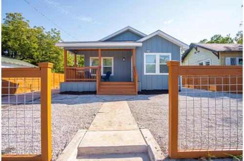 a house with a gate and a fence at Spectacular Brand New 4BR2.5BA Near DT Riverwalk in San Antonio