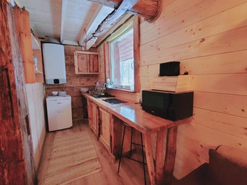 a kitchen with a wooden counter in a log cabin at Domki drewniane pod Karpaczem 9 osobowy in Mysłakowice