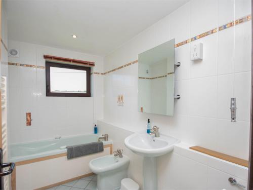 a white bathroom with a sink and a toilet at 3 Bed in Worth Matravers DC063 in Worth Matravers