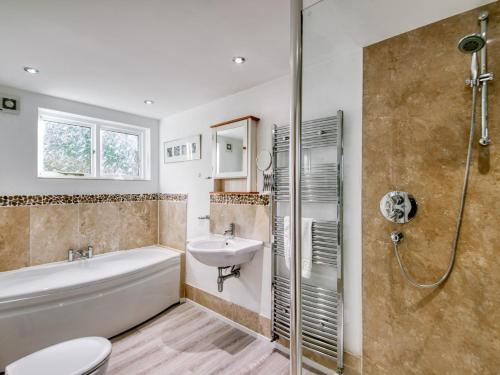 a bathroom with a tub and a sink and a shower at 4 bed property in Richmond 77835 in Richmond