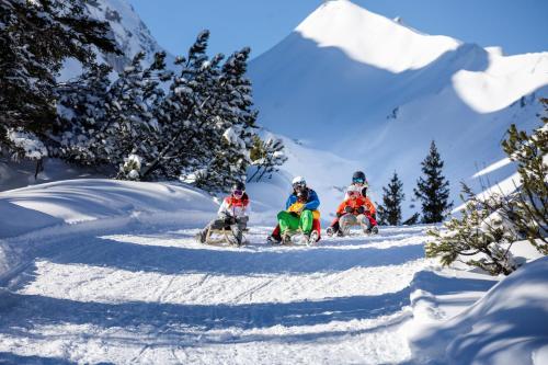 a group of people riding snow bikes in the snow at Chalet Mariedl in Schruns-Tschagguns