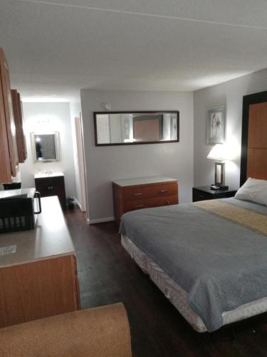 a hotel room with two beds and a desk at APM Inn and Suites in Winchester