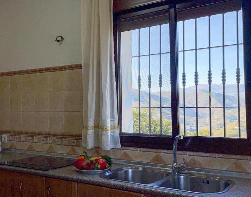 a kitchen counter with a sink and a window at El Mirador del Abuelo in Málaga