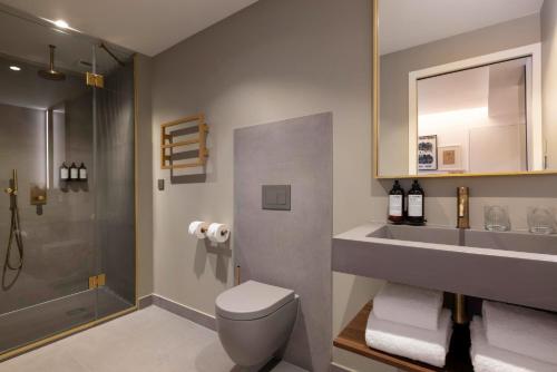 een badkamer met een toilet, een wastafel en een douche bij Hôtel Pilgrim in Parijs