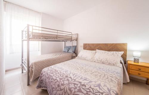 a bedroom with a bed and a bunk bed at Stunning apartment in Oropesa del Mar in Oropesa del Mar