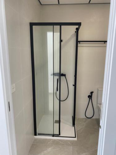 La salle de bains est pourvue d'une cabine de douche avec une porte en verre. dans l'établissement Glasshome, à La Vila Joiosa