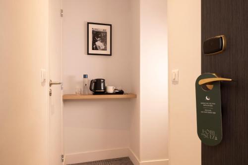 a room with a door with a sign on the wall at Hotel De Suez in Paris