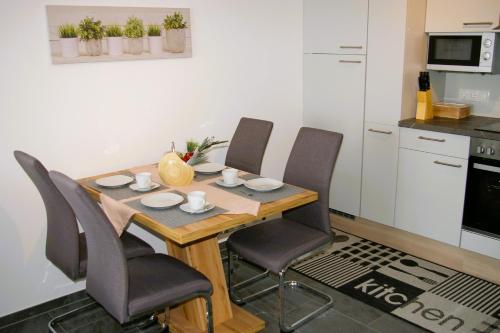 a dining room table with chairs and a kitchen at Sellraintaler Auszeit 2 in Sellrain