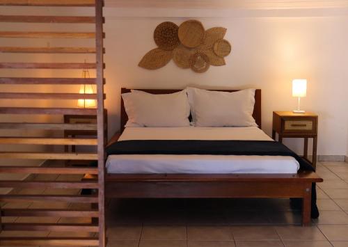 a bedroom with a bed with a wooden bed frame at Casa Aldeia Paraty in Paraty