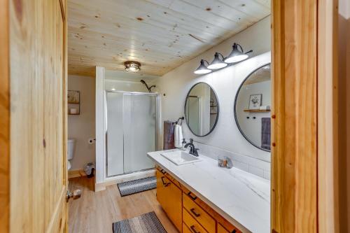 a bathroom with a sink and a shower and a mirror at Avery Creek Cabins Hike, Bike, Fish and More! 