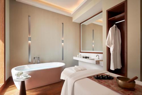 a bathroom with a tub and a sink at Anantara Downtown Dubai in Dubai