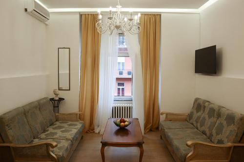 a living room with a couch and a table at Golden Velvet apartment Belgrade in Belgrade