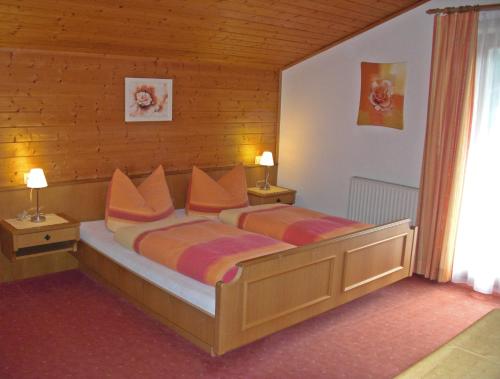 a bedroom with a bed with two pillows on it at Haus Marita in Sankt Leonhard im Pitztal