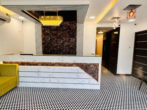 a lobby with a counter and stairs in a room at GREENS ELITE in Chennai