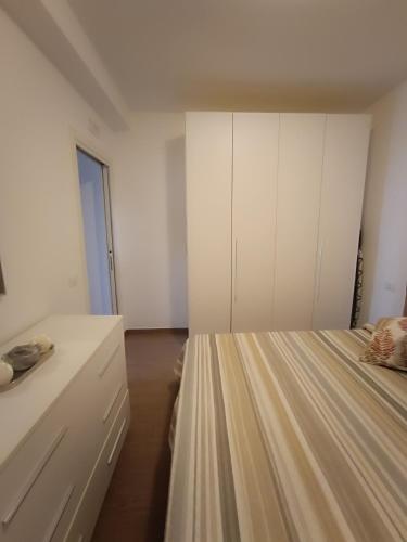a bedroom with white cabinets and a bed at Appartamento turistico Olivella in Formia