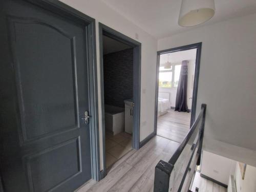 a hallway with a door leading to a bedroom at Adoniapro Clacton Lodge in Great Clacton