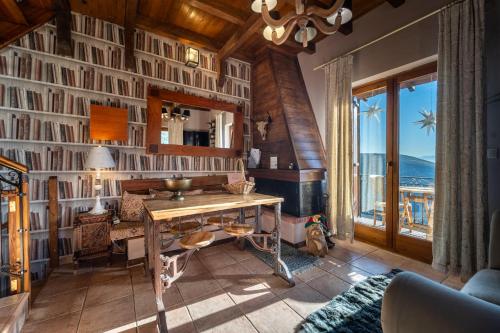 a living room with a table with a view of the ocean at Rock Dandy Deluxe Chalet in Arachova - Delphi, Sauna, Prv Parking, Amazing View in Arachova