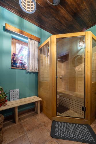 a sauna with a wooden cabinet and a bench in a room at Rock Dandy Deluxe Chalet in Arachova - Delphi, Sauna, Prv Parking, Amazing View in Arachova